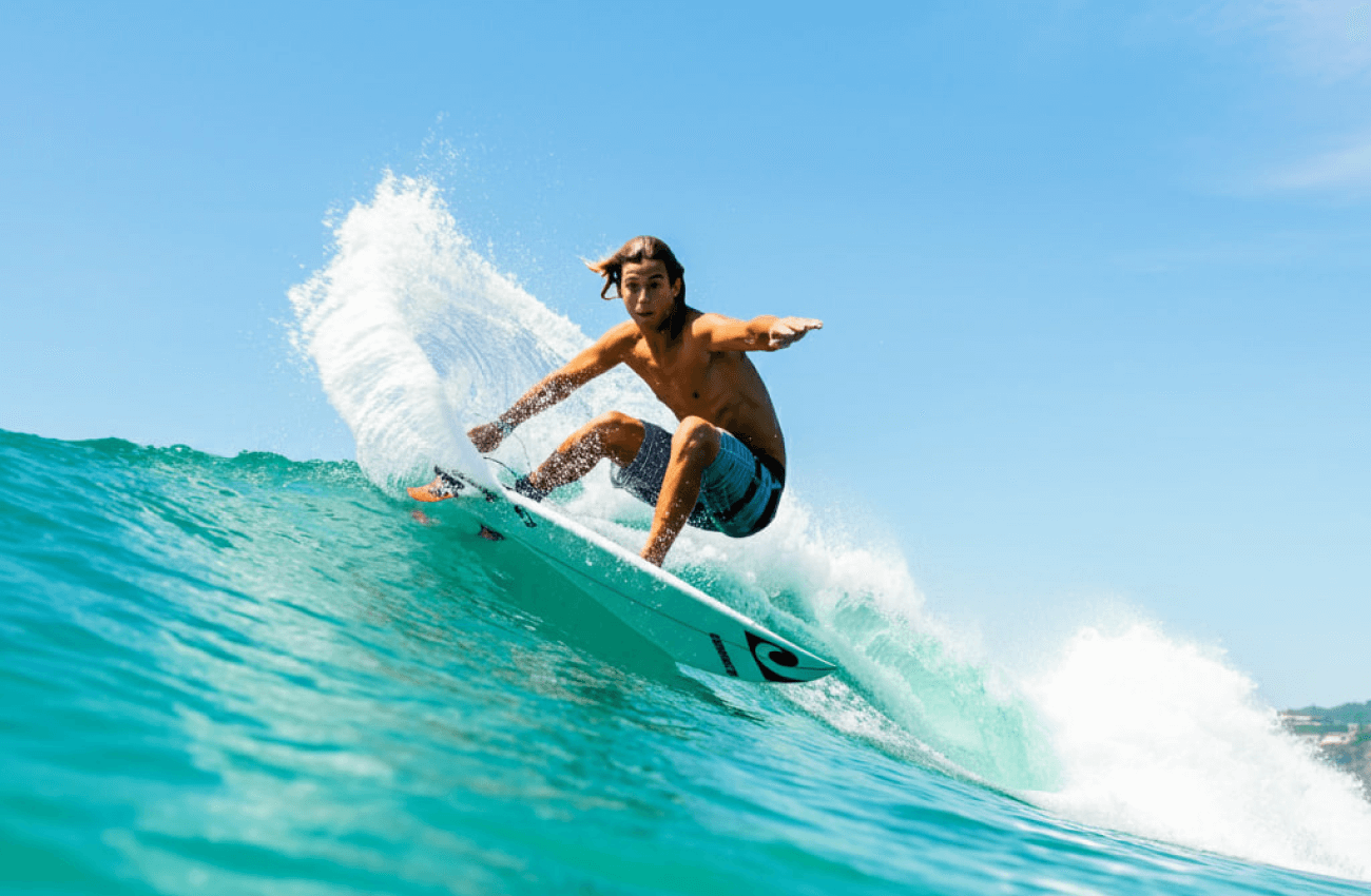 A man enjoying a day of surf in Phangan, riding a clean wave