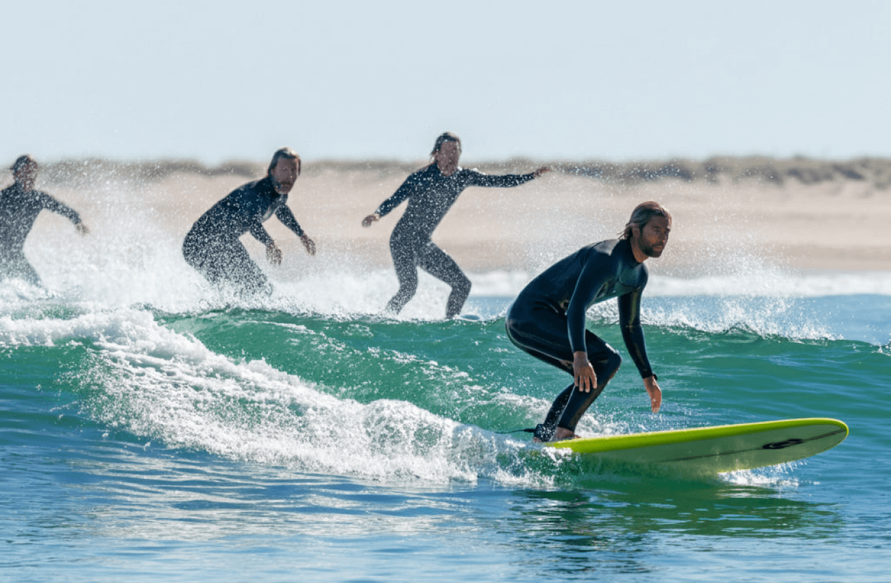 A group of beginners learning to surf at one of the best surf schools