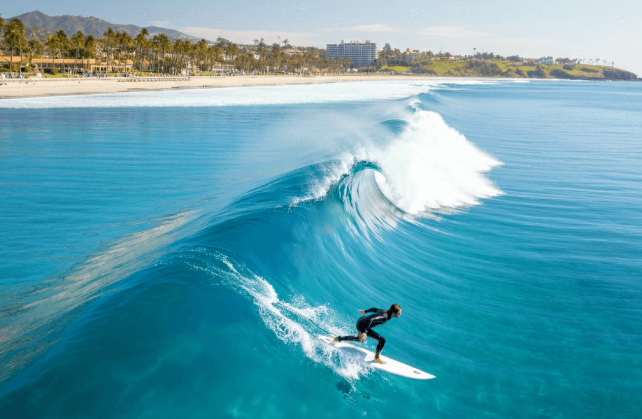 A surfer on a perfect wave, showcasing the best time to surf in Phangan